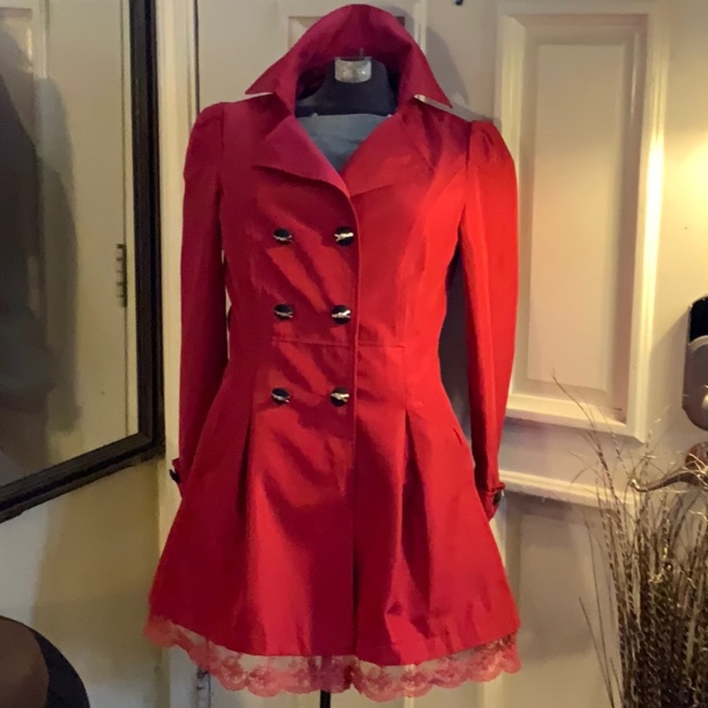 Cute double-breasted trench with lace peek-a-boo hem.
